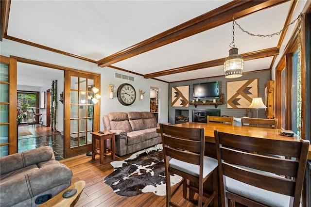 150 Buckwheat Dr, Pine Twp Nal, PA 15044 - living area featuring french doors, wood-type flooring, a brick fireplace, crown molding, and beam ceiling