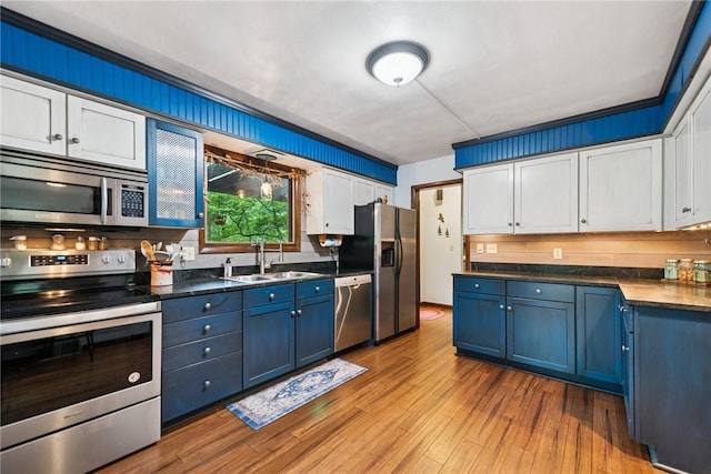 150 Buckwheat Dr, Pine Twp Nal, PA 15044 - kitchen featuring stainless steel appliances, blue cabinets, white cabinets, dark countertops, and wood finished floors
