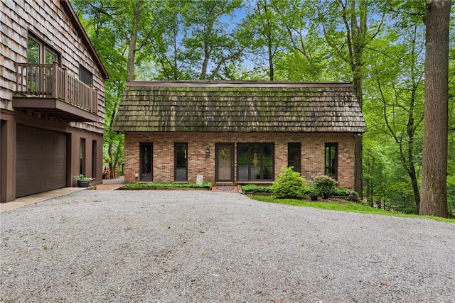 150 Buckwheat Dr, Pine Twp Nal, PA 15044 - view of front of house featuring brick siding, mansard roof, gravel driveway, and an attached garage