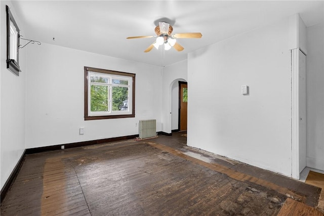 226 Herndon, Elliott, PA 15220 - empty room featuring radiator heating unit, arched walkways, ceiling fan, and hardwood / wood-style flooring