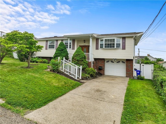 1032 Grove St, Monaca, PA 15061 - split foyer home featuring driveway, an attached garage, brick siding, and a gate