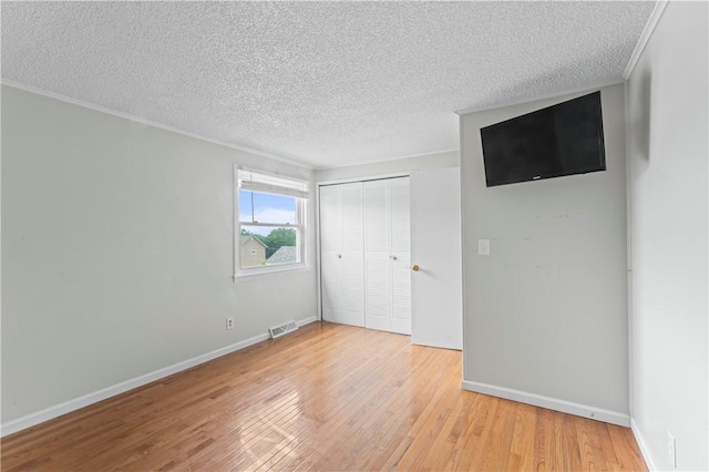 1032 Grove St, Monaca, PA 15061 - unfurnished bedroom featuring wood finished floors, a textured ceiling, a closet, and crown molding