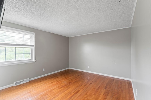 1032 Grove St, Monaca, PA 15061 - unfurnished room featuring light wood-style flooring, a textured ceiling, and ornamental molding