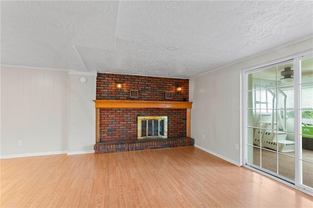 1032 Grove St, Monaca, PA 15061 - unfurnished living room with wood finished floors, a textured ceiling, a fireplace, and crown molding