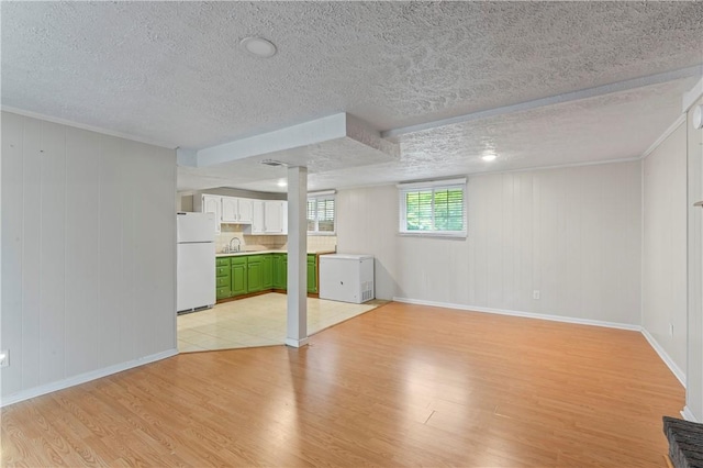 1032 Grove St, Monaca, PA 15061 - below grade area featuring freestanding refrigerator, light wood-type flooring, and a textured ceiling