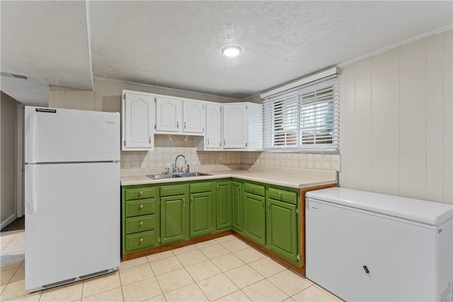 1032 Grove St, Monaca, PA 15061 - kitchen featuring freestanding refrigerator, fridge, a textured ceiling, white cabinetry, and green cabinetry