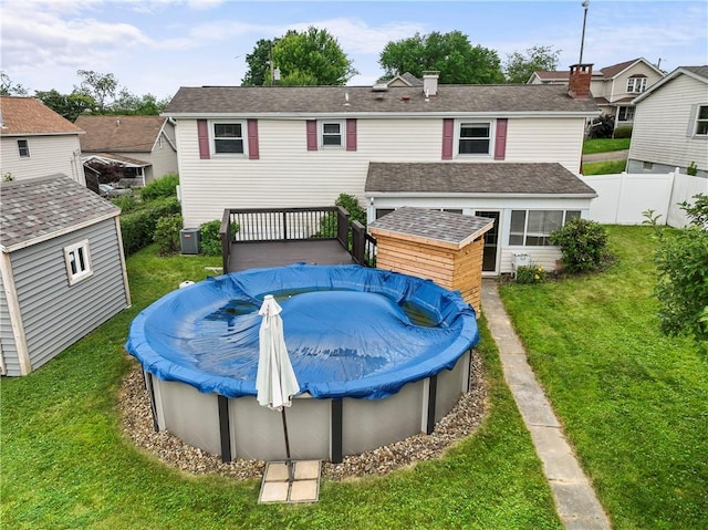 1032 Grove St, Monaca, PA 15061 - back of house featuring a covered pool, a residential view, a chimney, a shingled roof, and a wooden deck