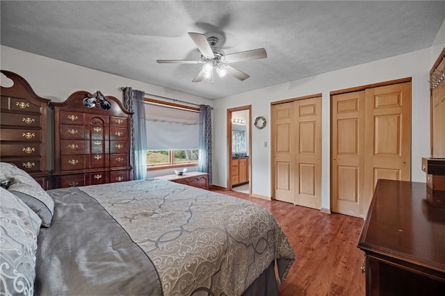 321 Dairy Farm Rd, Allegheny Twp Wml, PA 15068 - bedroom with multiple closets, a textured ceiling, wood finished floors, and a ceiling fan