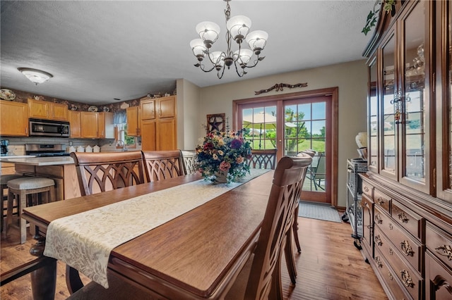 321 Dairy Farm Rd, Allegheny Twp Wml, PA 15068 - dining area with a chandelier, light wood-style flooring, and a textured ceiling