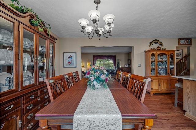 321 Dairy Farm Rd, Allegheny Twp Wml, PA 15068 - dining area featuring a chandelier, wood finished floors, and a textured ceiling