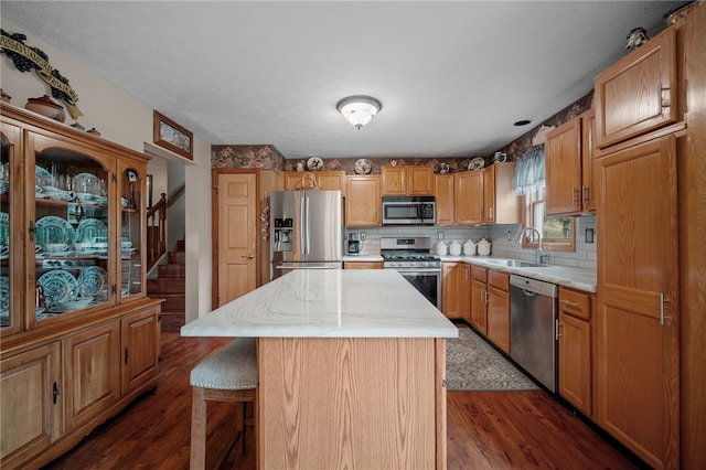321 Dairy Farm Rd, Allegheny Twp Wml, PA 15068 - kitchen with stainless steel appliances, a center island, dark wood-type flooring, a breakfast bar area, and backsplash