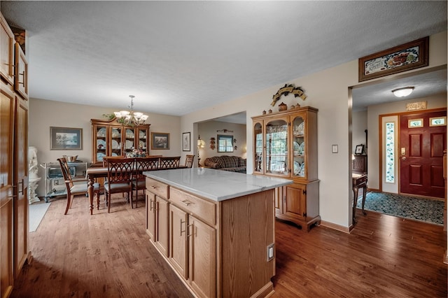 321 Dairy Farm Rd, Allegheny Twp Wml, PA 15068 - kitchen featuring wood finished floors, a chandelier, a kitchen island, and decorative light fixtures