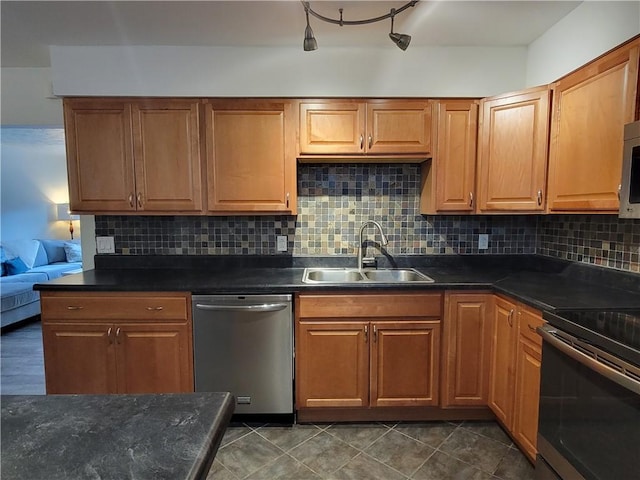 611 Broadhead Ave, Crafton, PA 15205 - kitchen with appliances with stainless steel finishes, dark countertops, backsplash, and brown cabinets