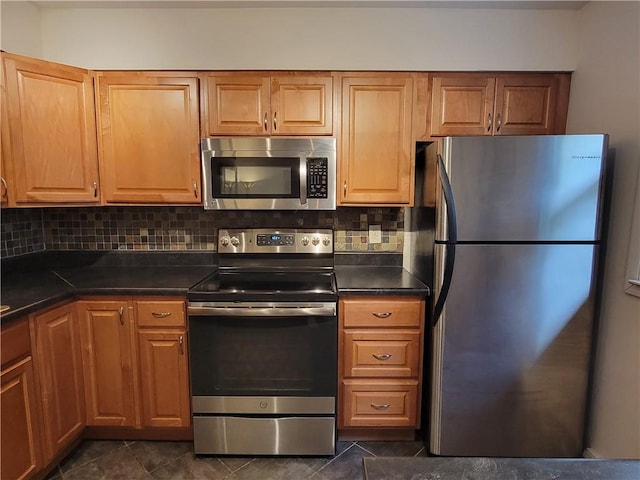 611 Broadhead Ave, Crafton, PA 15205 - kitchen featuring appliances with stainless steel finishes, dark countertops, backsplash, and dark tile patterned flooring