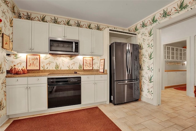 274 Rector Rd, Ligonier Twp, PA 15658 - kitchen featuring black appliances, wallpapered walls, white cabinets, light countertops, and light stone finish floors