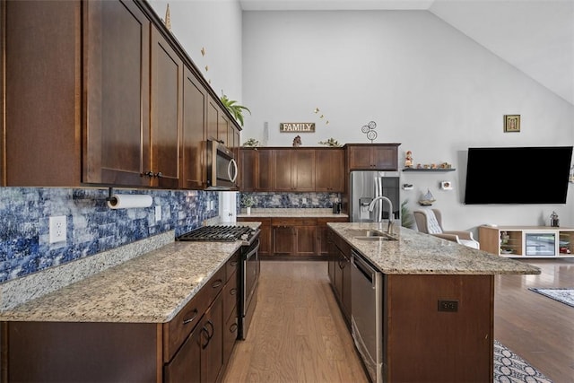 503 Tuscarora Rd, Marshall, PA 16046 - kitchen with stainless steel appliances, high vaulted ceiling, light wood finished floors, decorative backsplash, and dark brown cabinetry