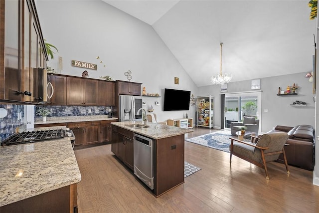 503 Tuscarora Rd, Marshall, PA 16046 - kitchen with stainless steel appliances, open floor plan, high vaulted ceiling, a chandelier, and wood finished floors