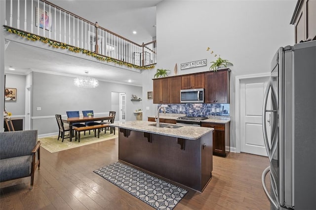 503 Tuscarora Rd, Marshall, PA 16046 - kitchen with appliances with stainless steel finishes, a towering ceiling, light stone countertops, a breakfast bar area, and a chandelier