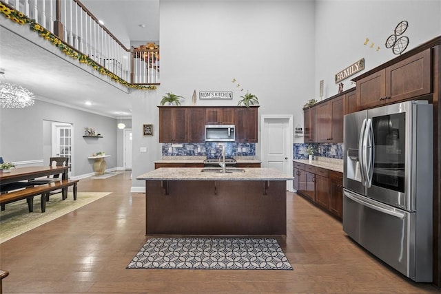 503 Tuscarora Rd, Marshall, PA 16046 - kitchen with appliances with stainless steel finishes, a towering ceiling, tasteful backsplash, dark brown cabinetry, and light stone counters