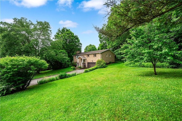 202 Village Ln, New Wilmington Boro, PA 16142 - view of green lawn with a garage and driveway