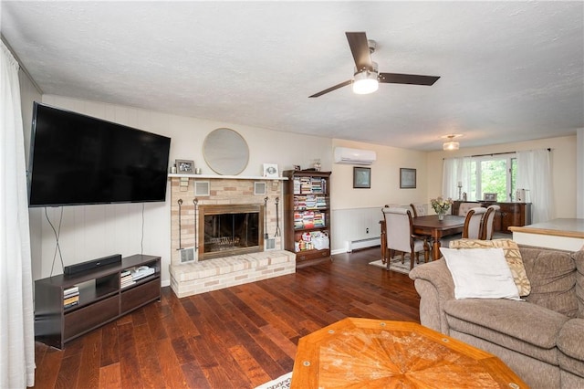 202 Village Ln, New Wilmington Boro, PA 16142 - living room with baseboard heating, a wall unit AC, hardwood / wood-style flooring, and a ceiling fan