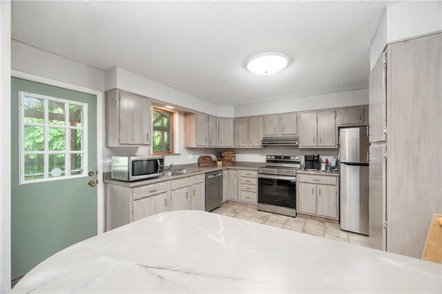 202 Village Ln, New Wilmington Boro, PA 16142 - kitchen with appliances with stainless steel finishes, healthy amount of natural light, light countertops, and under cabinet range hood
