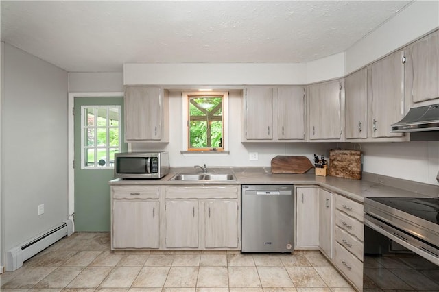 202 Village Ln, New Wilmington Boro, PA 16142 - kitchen with appliances with stainless steel finishes, under cabinet range hood, baseboard heating, and light countertops