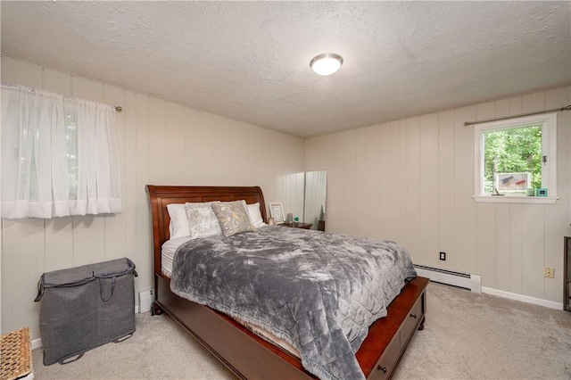 202 Village Ln, New Wilmington Boro, PA 16142 - carpeted bedroom featuring a baseboard radiator and a textured ceiling