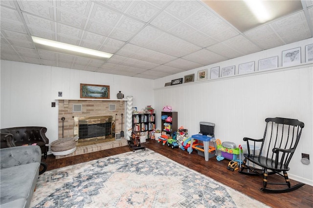 202 Village Ln, New Wilmington Boro, PA 16142 - recreation room featuring wood finished floors and a brick fireplace