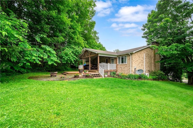 202 Village Ln, New Wilmington Boro, PA 16142 - back of property with a fire pit, a chimney, a lawn, and brick siding