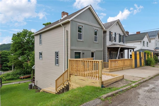634 Euclid Ave, Canonsburg, PA 15317 - view of front facade with board and batten siding, a deck, roof with shingles, and a chimney