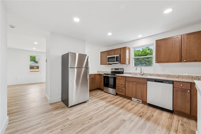 634 Euclid Ave, Canonsburg, PA 15317 - kitchen with appliances with stainless steel finishes, light wood finished floors, brown cabinetry, and recessed lighting