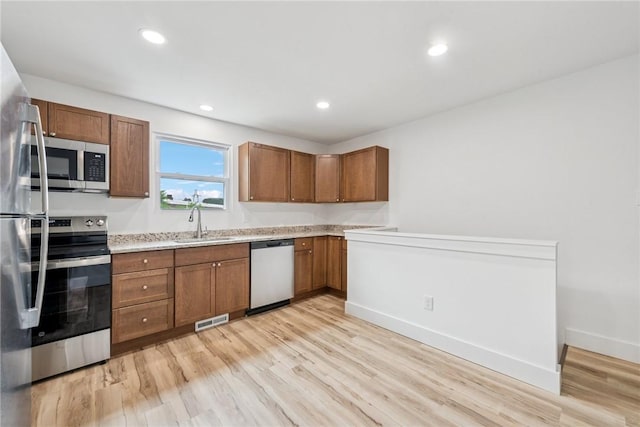 634 Euclid Ave, Canonsburg, PA 15317 - kitchen featuring appliances with stainless steel finishes, light wood finished floors, brown cabinetry, and recessed lighting