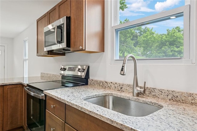 634 Euclid Ave, Canonsburg, PA 15317 - kitchen with appliances with stainless steel finishes, light stone counters, and brown cabinets