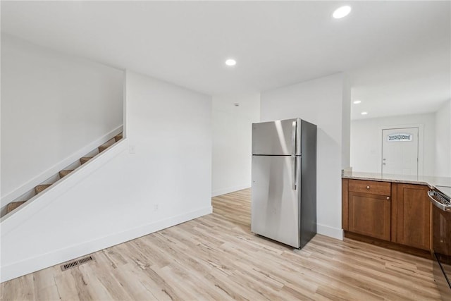 634 Euclid Ave, Canonsburg, PA 15317 - kitchen with freestanding refrigerator, brown cabinetry, recessed lighting, light wood finished floors, and range