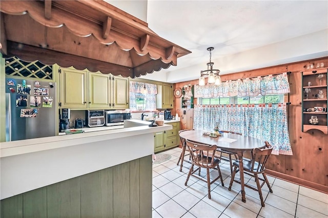 570 S 7th St, Sharpsville, PA 16150 - kitchen with green cabinetry, stainless steel appliances, light tile patterned flooring, light countertops, and pendant lighting
