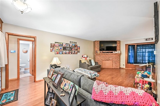 570 S 7th St, Sharpsville, PA 16150 - living area featuring wood finished floors and a brick fireplace