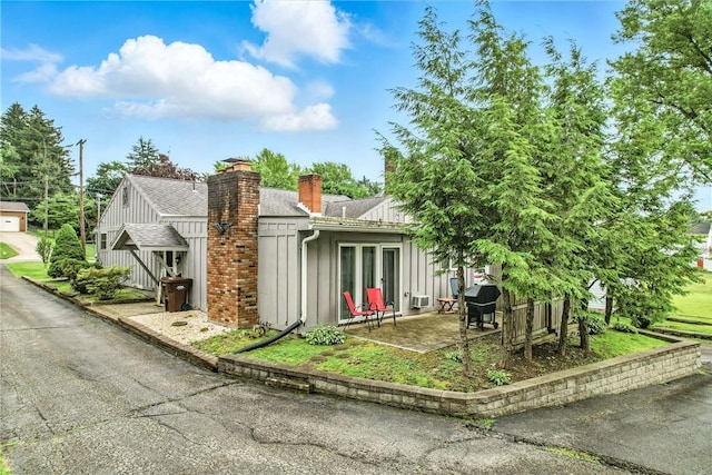 570 S 7th St, Sharpsville, PA 16150 - view of front of property featuring a chimney, a patio, and roof with shingles