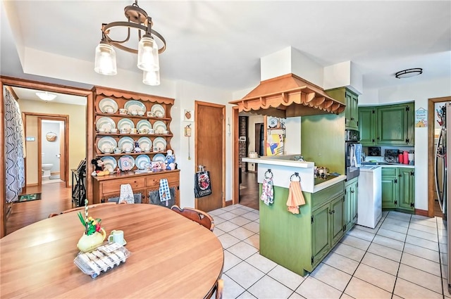 570 S 7th St, Sharpsville, PA 16150 - kitchen with green cabinetry, light countertops, black oven, and custom exhaust hood