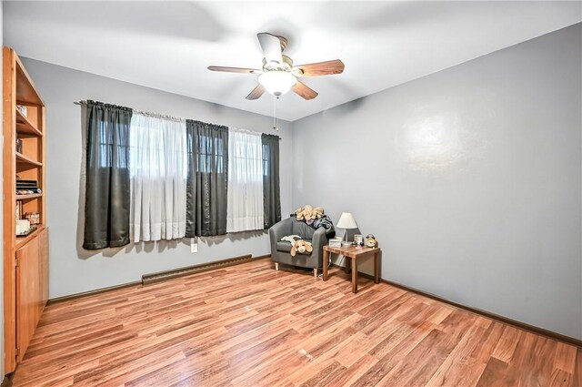 570 S 7th St, Sharpsville, PA 16150 - living area with ceiling fan, light wood finished floors, and a baseboard heating unit