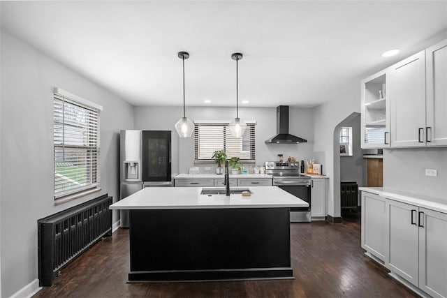 171 Clearview Ave, Ross Twp, PA 15229 - kitchen with stainless steel appliances, wall chimney exhaust hood, radiator heating unit, light countertops, and recessed lighting