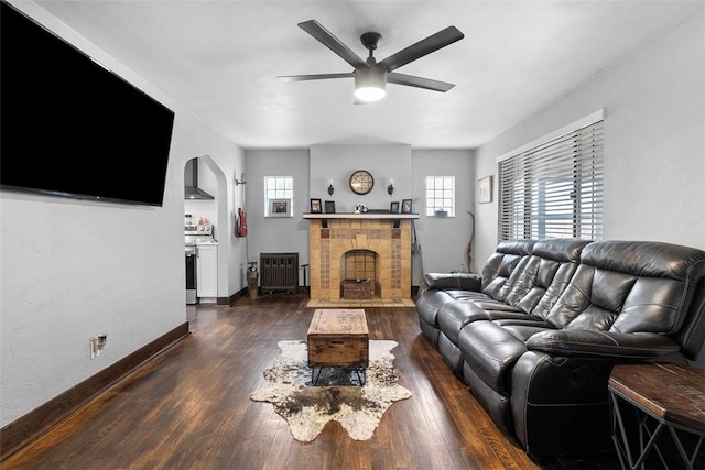 171 Clearview Ave, Ross Twp, PA 15229 - living area with a ceiling fan, a fireplace, arched walkways, and dark wood finished floors