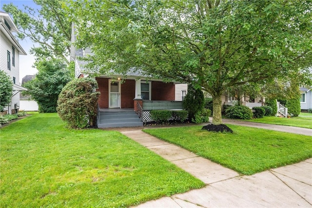 1204 Griswold St, Sharon, PA 16146 - view of front facade featuring covered porch, a front lawn, and brick siding