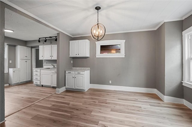 1204 Griswold St, Sharon, PA 16146 - kitchen featuring a chandelier, light wood finished floors, white cabinetry, light countertops, and crown molding