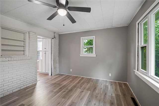 1204 Griswold St, Sharon, PA 16146 - empty room with brick wall, wood finished floors, ceiling fan, and ornamental molding