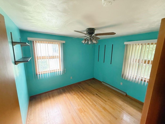 717 King St, Mckeesport, PA 15132 - unfurnished room featuring baseboard heating, ceiling fan, wood finished floors, and a smoke detector