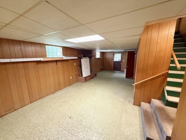 717 King St, Mckeesport, PA 15132 - below grade area with stairway, tile patterned floors, wooden walls, and a drop ceiling