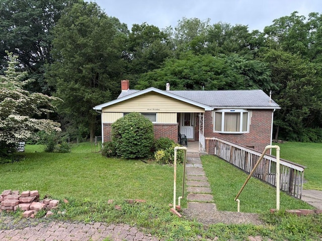 717 King St, Mckeesport, PA 15132 - bungalow-style home with brick siding, a front lawn, and a chimney