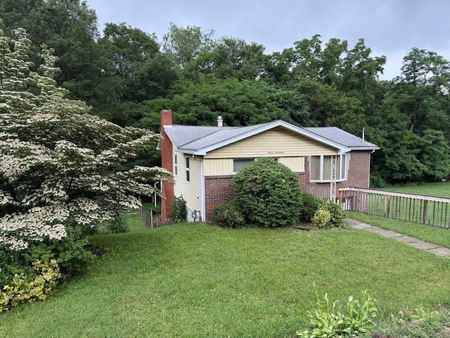717 King St, Mckeesport, PA 15132 - view of side of property with a chimney and brick siding