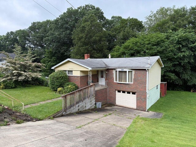 717 King St, Mckeesport, PA 15132 - ranch-style house featuring brick siding, concrete driveway, a front yard, and a garage